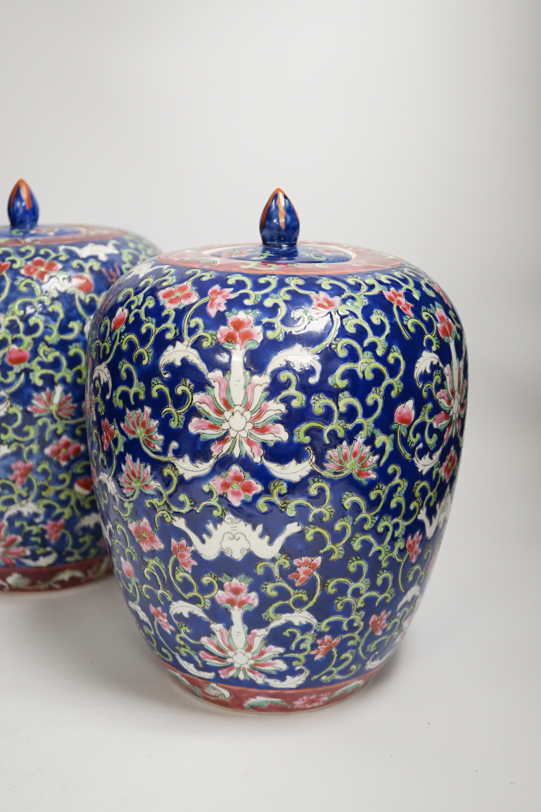 A pair of Chinese blue ground jars and covers, 29cm